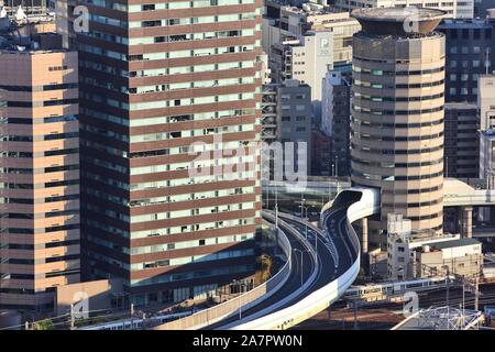 OSAKA, JAPAN - APRIL 27, 2012: Road goes through Gate Tower Building in Osaka, Japan. The building is extremely popular because of highway crossing th Stock Photo