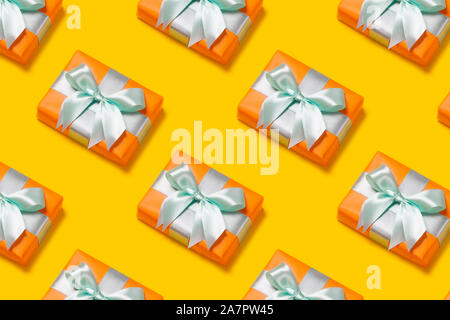 Pattern with stylish gift on a trendy orange background. Present for St. Valentine's day, engagements, Mother's Day, birthday, New Year, Christmas, holidays Stock Photo