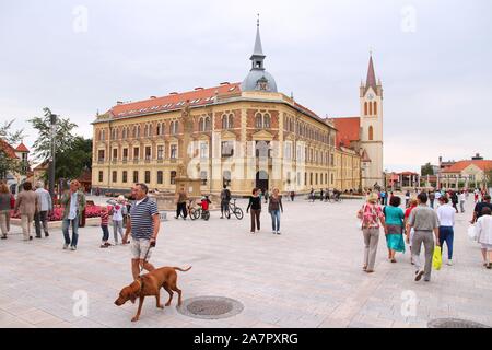 KESZTHELY, HUNGARY - AUGUST 11, 2012: People visit main square in Keszthely, Hungary. In 2011 tourism receipts in Hungary brought 4.03 billion EUR to Stock Photo