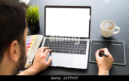 graphic designer working on laptop mock up Stock Photo