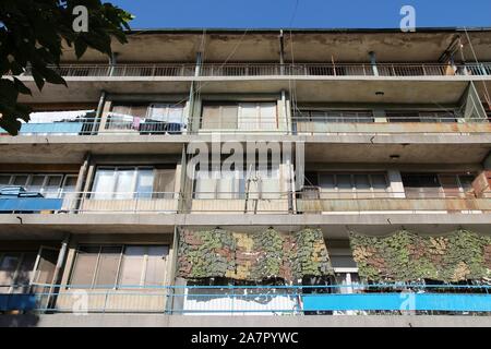 Vidin, Bulgaria - old communist apartment building. Damaged residential architecture. Stock Photo