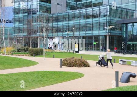 MANCHESTER, UK - APRIL 22, 2013: People visit the MediaCityUK in Salford, Manchester, UK. MediaCityUK is a 200-acre development completed in 2011, use Stock Photo