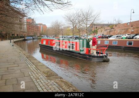 MANCHESTER, UK - APRIL 21, 2013: People visit Castlefield canal area in Manchester, UK. Castlefield is an Urban Heritage Park since 1982. Stock Photo