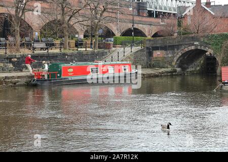 MANCHESTER, UK - APRIL 21, 2013: People visit Castlefield canal area in Manchester, UK. Castlefield is an Urban Heritage Park since 1982. Stock Photo