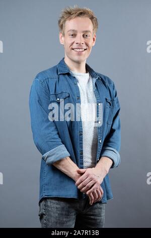 Dresden, Germany. 30th Oct, 2019. The actor Oliver Morschel stands in front of a photo wall in the boulevard theatre. The occasion is the presentation of the musical 'Frank Schöbel Story', which deals with the career of the GDR hit singer Frank Schöbel on stage. Credit: Sebastian Kahnert/dpa-Zentralbild/dpa/Alamy Live News Stock Photo