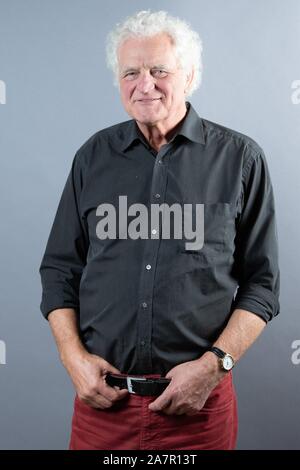 Dresden, Germany. 30th Oct, 2019. Director Jürgen Mai stands in front of a photo wall in the boulevard theatre. The occasion is the presentation of the musical 'Frank Schöbel Story', which deals with the career of the GDR hit singer Frank Schöbel on stage. Credit: Sebastian Kahnert/dpa-Zentralbild/dpa/Alamy Live News Stock Photo