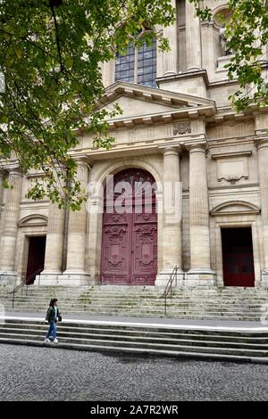 Asian woman walking past the Church of Saint-Gervais-et-Saint-Protais, Paris, France. Stock Photo