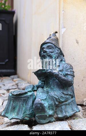 WROCLAW, POLAND - MAY 11, 2018: Gnome or dwarf small statue in Wroclaw, Poland. Wroclaw has 350 gnome sculptures around the city. Stock Photo
