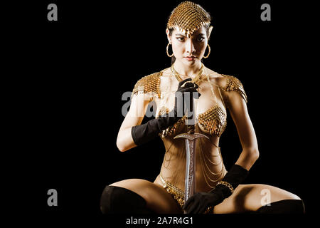 Sexy girl wearing golden queen of warrior armor fancy dress looks elegant and luxury for advertising fashion model Stock Photo - Alamy Sexy girl wearing golden queen of warrior armor fancy dress looks elegant and luxury for advertising fashion model Stock Photo - Alamy