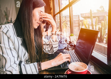 Business woman eye pain strain fatigue from computer vision syndrome.