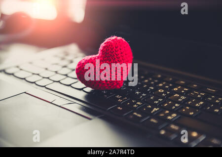 Red heart on computer laptop keyboard for love chat online dating Stock Photo