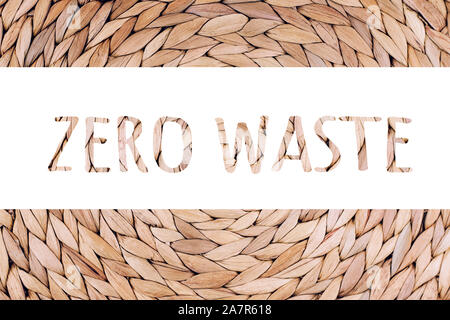 Zero Waste words on handmade wicker placemat made from water hyacinth. Top view, nature background. Stock Photo