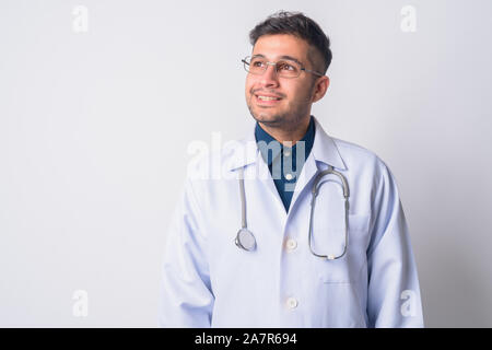 Portrait of happy Persian man doctor thinking Stock Photo