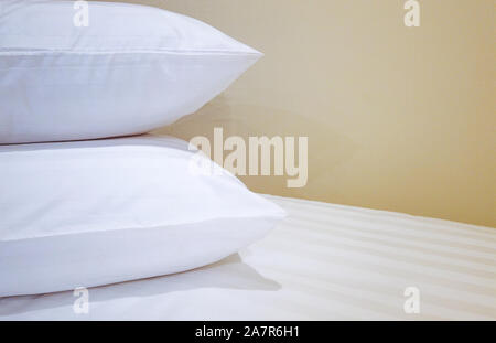 double pillows on bed which preparing for guest background. Stock Photo