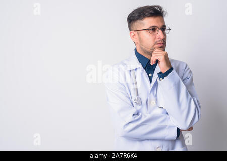Portrait of young Persian man doctor thinking Stock Photo