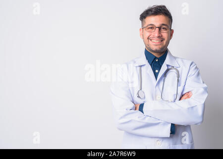 Portrait of happy Persian man doctor smiling with arms crossed Stock Photo