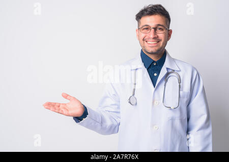Portrait of happy Persian man doctor showing something Stock Photo