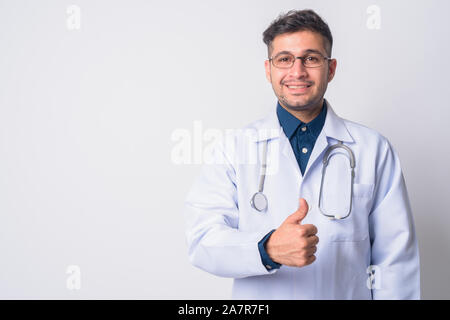 Portrait of happy Persian man doctor giving thumbs up Stock Photo