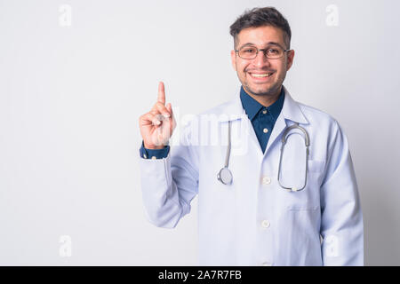 Portrait of happy Persian man doctor pointing up Stock Photo
