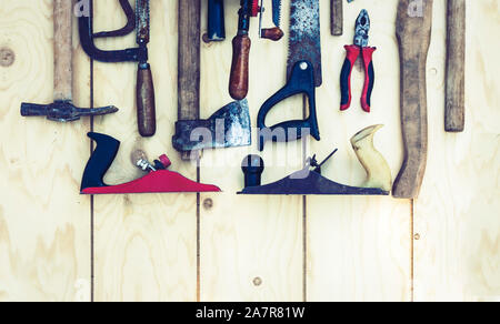 Set of vintage hand construction tools hammers on a wooden background, retro concept Stock Photo