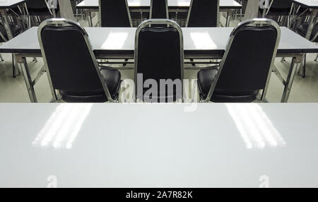 Empty nobody chairs and desks in classroom background. Stock Photo