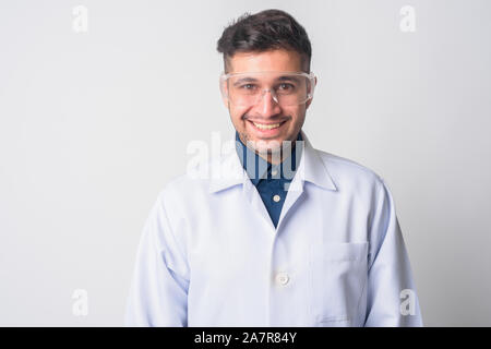 Face of happy Persian man doctor as scientist smiling Stock Photo