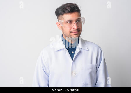 Face of young Persian man doctor as scientist thinking Stock Photo