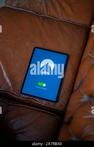 Tablet with VPN application on is laying down on the sofa Stock Photo
