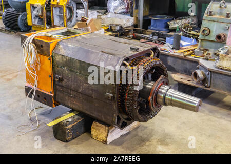 disassembled large industrial electric motor in the repair process in the workshop Stock Photo