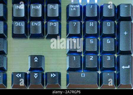 Numeric keypad black keyboard with blue backlight close-up Stock Photo