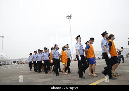 Charter flight carrying swindlers caught in a cross-border cooperation between Chinese and Cambodian police lands and swindlers are transferred to loc Stock Photo