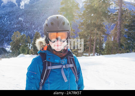 Woman in helmet and mask with snowboard on ski resort. Portrait girl snowboard closeup. Travel Lifestyle winter adventure concept, activities vacation Stock Photo