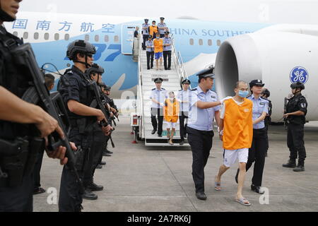 Charter flight carrying swindlers caught in a cross-border cooperation between Chinese and Cambodian police lands and swindlers are transferred to loc Stock Photo