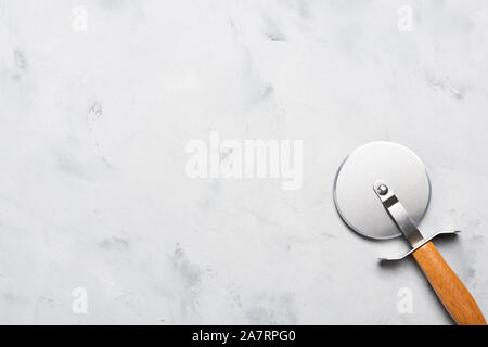 Pizza cutter with wooden handle on table top view Stock Photo