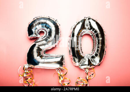 Balloon Bunting for celebration Happy 20th Anniversary made from Silver Number Balloons. Holiday Party Decoration or postcard concept with top view an Stock Photo