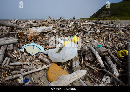 Plastic pollution nets bottles foam on ocean shore Stock Photo