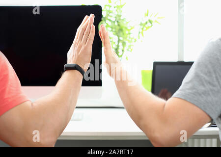 Two male hand in office hive five Stock Photo