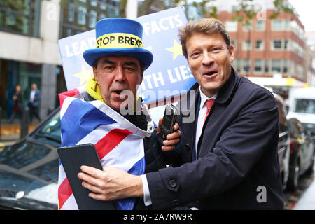 Brexit Party chairman Richard Tice (right) with anti-Brexit protestor Steve Bray ahead of the upcoming General Election in Westminster, London. Stock Photo