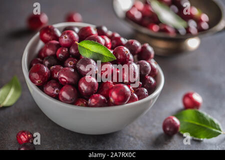 Fresh ripe cranberries in bowl on table close-up Stock Photo