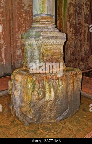 ISTANBUL TURKEY THE BASILICA CISTERN COLUMNS SUPERB MARBLE MEDUSA HEAD SCULPTURE USED AS A COLUMN BASE LYING IN A POOL OF WATER Stock Photo