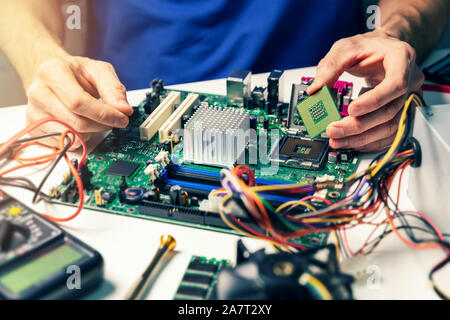 installing computer hardware - technician install CPU on motherboard Stock Photo