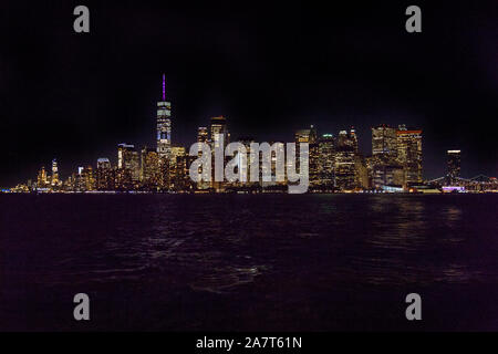 Manhattan island at night, photographed from the Staten Island Ferry, New York City, United States of America. Stock Photo