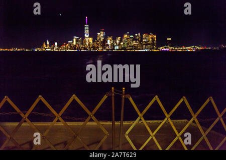 Manhattan island at night, photographed from the Staten Island Ferry, New York City, United States of America. Stock Photo