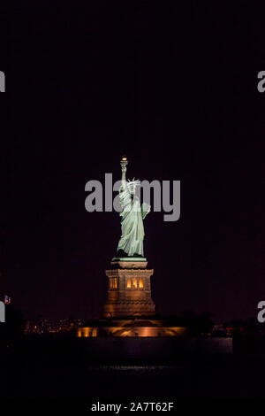 Statue of Liberty at night photographed from the Staten Island Ferry, New York City, United States of America. Stock Photo