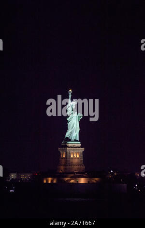 Statue of Liberty at night photographed from the Staten Island Ferry, New York City, United States of America. Stock Photo