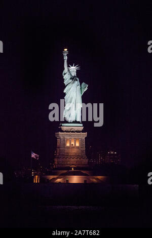 Statue of Liberty at night photographed from the Staten Island Ferry, New York City, United States of America. Stock Photo