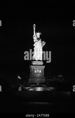 Statue of Liberty at night photographed from the Staten Island Ferry, New York City, United States of America. Stock Photo