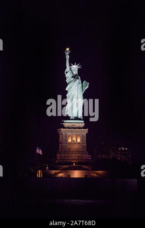 Statue of Liberty at night photographed from the Staten Island Ferry, New York City, United States of America. Stock Photo