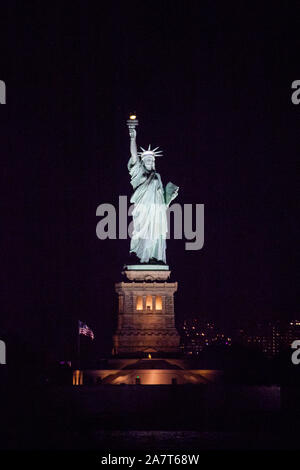 Statue of Liberty at night photographed from the Staten Island Ferry, New York City, United States of America. Stock Photo