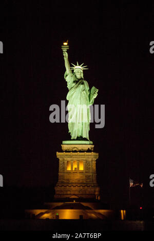 Statue of Liberty at night photographed from the Staten Island Ferry, New York City, United States of America. Stock Photo